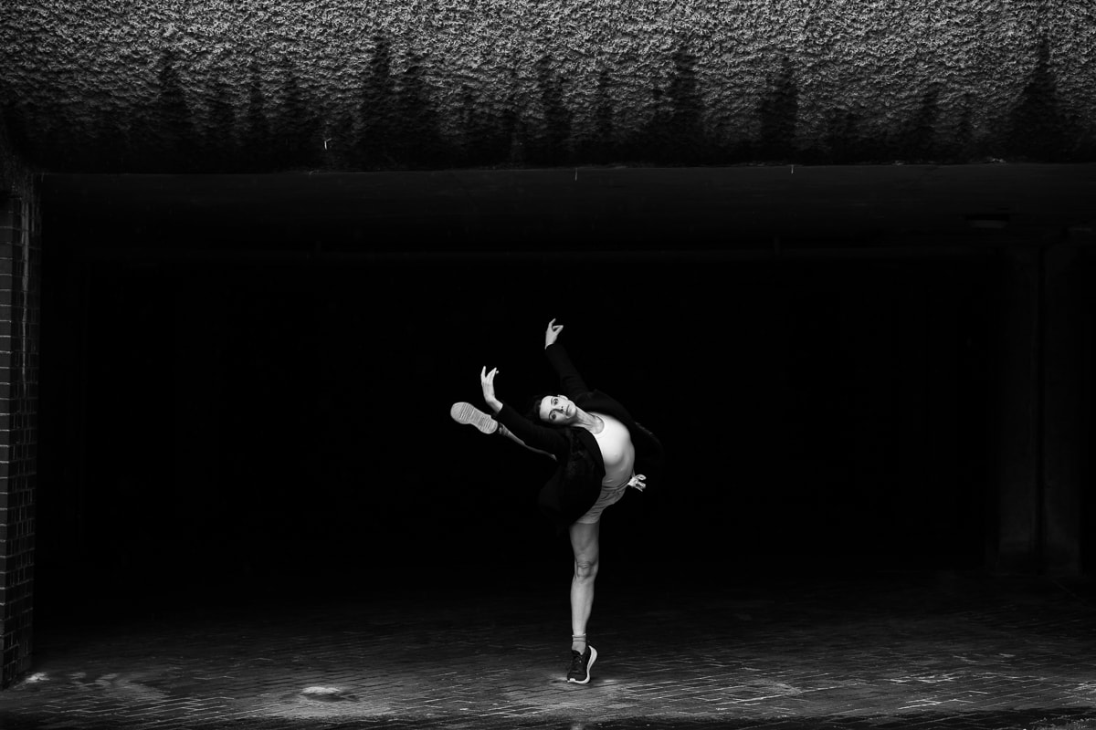 Dancer in dramatic mid-leap, captured in black and white