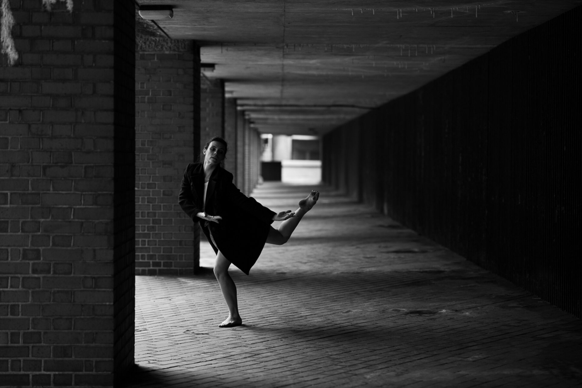 Contemporary dancer in an urban brick corridor