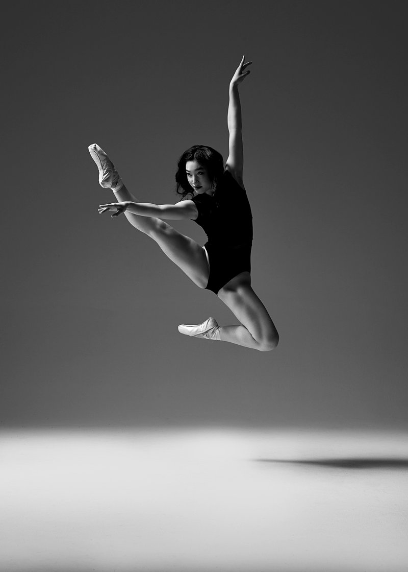 Ayaki Lai performing an aerial ballet leap in the studio